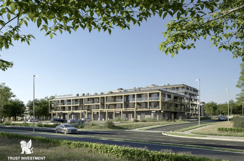 widok z perspektywy pieszego na bloki wielorodzinne z zielonymi dachami